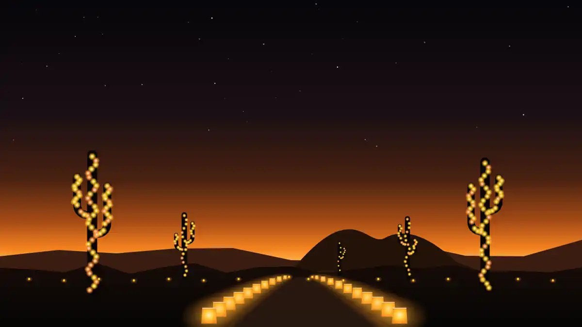 Saguaro cacti wrapped in Christmas lights beside a luminaria-lined desert path at dusk in Arizona