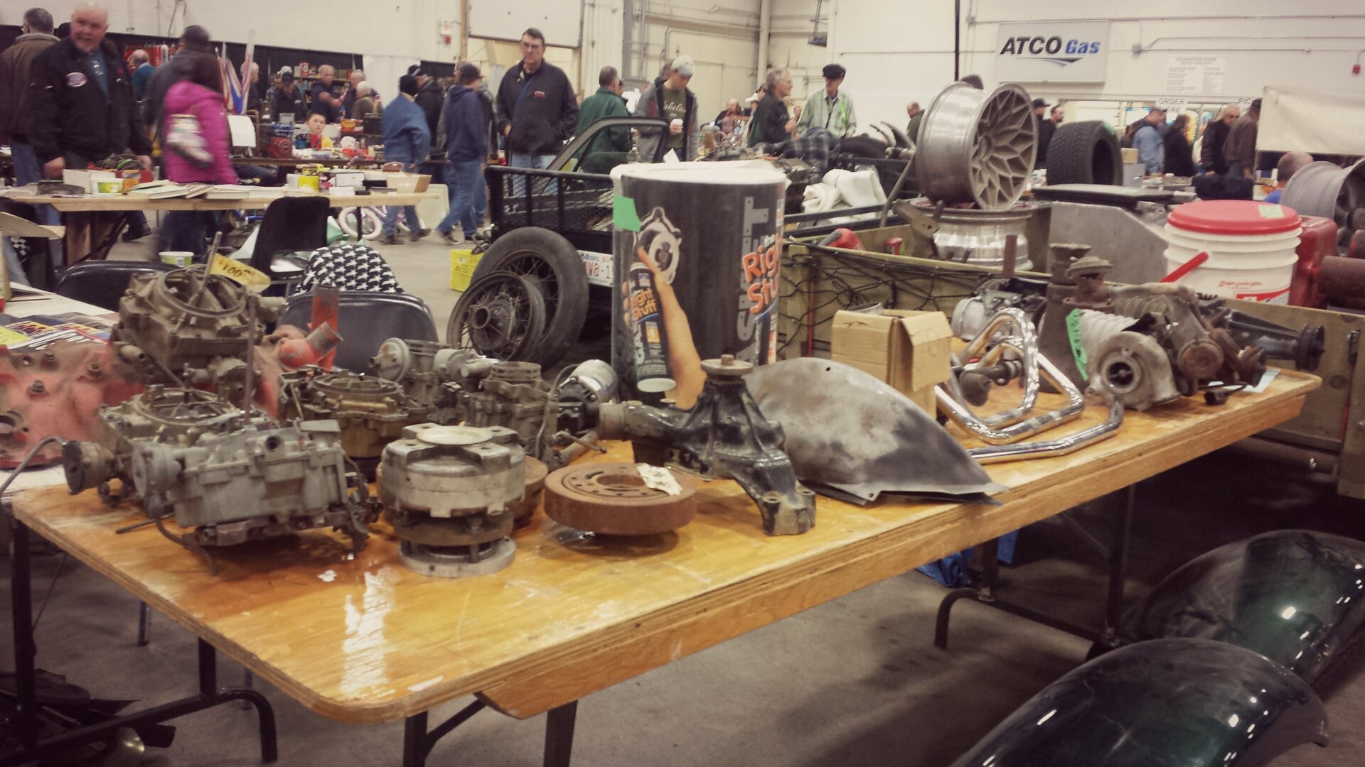 Vendor tables covered with secondhand goods at a swap meet